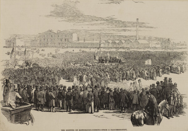 A large crowd of Chartists gathered on Kennington Common around speakers on a platform. In the distance can be seen buildings and factories.  Prints 020/024b