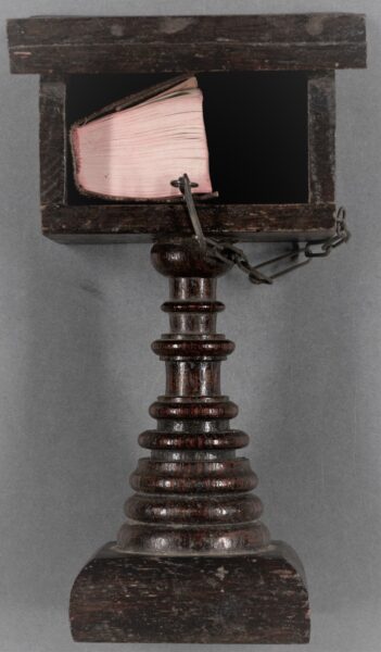 Miniature chained Bible on wooden lectern